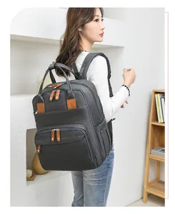 Close-up of grey backpack with premium leather pullers and durable oxford fabric details