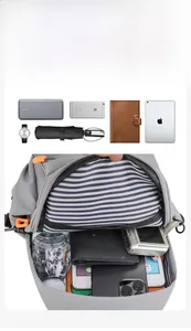 Detail view of the spacious inner compartment with striped lining and orange zippers