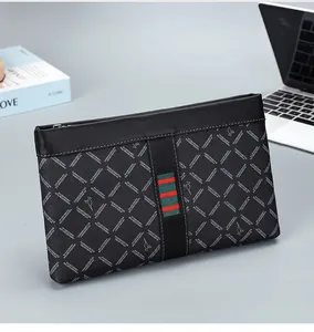 Close-up of black men's business clutch with kangaroo logo and iconic striped webbing