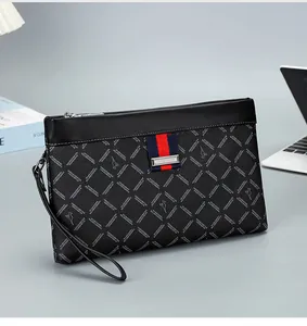Detail of men's business clutch bag showing red-blue stripes and kangaroo logo on desk