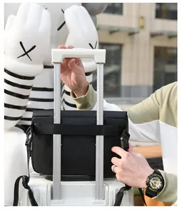 Detail of black crossbody bag featuring a luggage trolley strap and durable nylon fabric