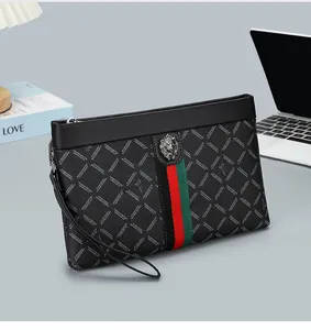 Detail of men's business clutch bag with metal lion head logo and signature webbing