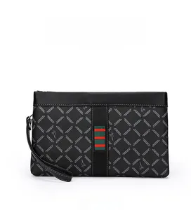 Detailed view of the diamond quilt pattern and signature stripe on the black men's clutch