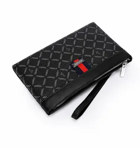 Detail of black men's clutch bag with textured lettering and red blue striped ribbon