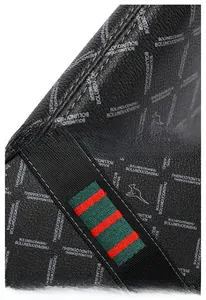 Detail of black leather clutch with signature green and red stripe and reinforced stitching