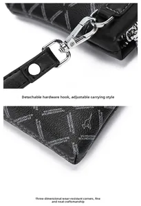 Detail of premium textured leather clutch with silver metal hook and reinforced corners