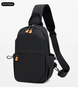 Detail of black tactical chest bag showing water-resistant fabric and orange zipper accents