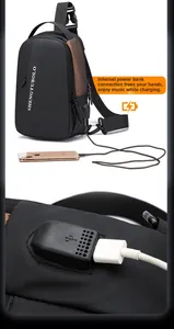 Detail of men's crossbody chest bag showing the integrated USB charging port and cable