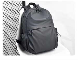 Detail of dark grey water-resistant backpack showing textile texture and top handle