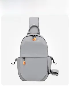 Front view of a grey nylon chest bag with multiple pockets and orange zipper accents