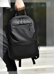 Detail view of water-resistant black laptop backpack with multiple zipper pockets