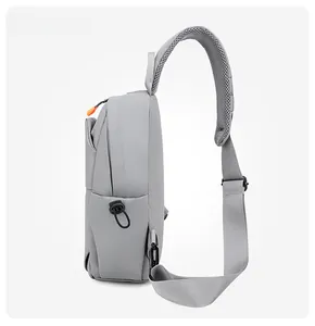 Side view of grey nylon chest bag with orange zipper details and breathable mesh strap