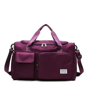 Bolso de viaje grande de nailon morado oscuro con correa y múltiples bolsillos