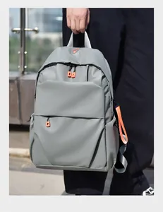 Detail of light grey waterproof backpack with orange zippers and contrast strap detail