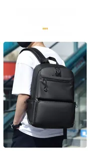 Detail of black waterproof nylon backpack with multiple zipper pockets and knotted pullers
