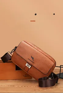 Detail shot of brown lychee texture leather crossbody bag with metal buckle closure