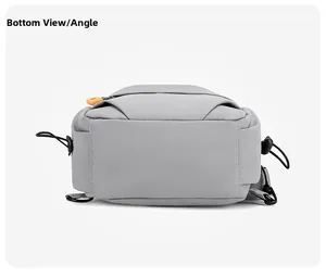 Detailed bottom view of grey nylon sports chest bag featuring orange zipper accents