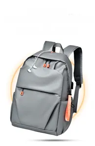 Detail of grey laptop backpack with orange accents, USB port and earphone jack