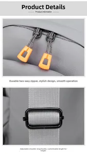 Detail of grey crossbody bag showing orange two-way zippers and black adjustable buckle