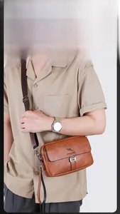 Brown litchi grain leather crossbody bag with adjustable strap and kangaroo logo detail