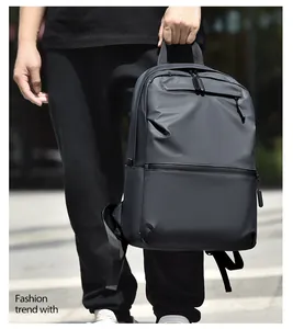 Detail of water-resistant dark grey fabric and zipper pockets on minimalist backpack