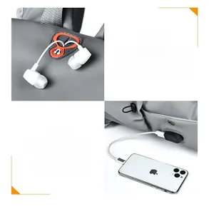 Detail view of water-resistant headphone port and USB charging port on a grey backpack