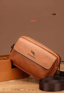 Detail of brown vintage faux leather texture and kangaroo logo on the small crossbody bag