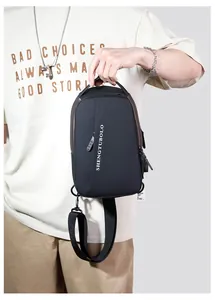 Detailed view of black nylon chest bag featuring a top handle and logo print