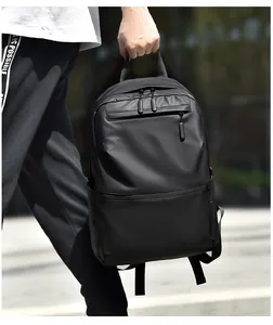 Detail shot of the matte black waterproof fabric and layered zipper pockets of the backpack