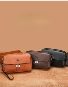 Detailed view of men's leather crossbody bags in brown and black with metal buckle