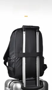 Detail of travel backpack with integrated trolley sleeve fixed on silver suitcase handle