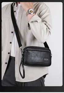 Detail of men's black lychee pattern leather crossbody bag with adjustable strap