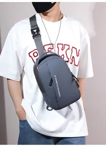 Detail of dark grey waterproof nylon chest bag with adjustable strap and brand logo