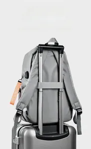 Waterproof grey business backpack featuring a luggage strap for easy travel attachment