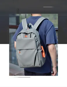 Detail view of grey waterproof laptop backpack with vibrant orange zipper accents