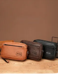 Detailed view of three vintage leather shoulder bags in black, brown, and dark coffee