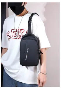 Detail of black sports crossbody bag with USB port and adjustable buckle strap