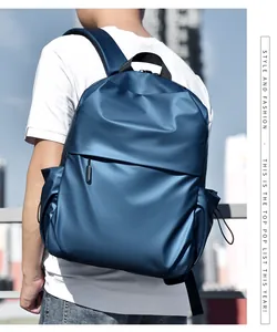 Detail view of water-resistant navy blue backpack with adjustable side pockets and sleek finish