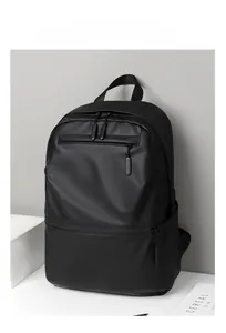 Detail of minimalist black backpack with waterproof matte finish and front zipper compartment