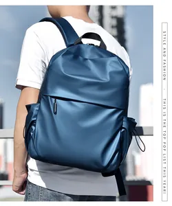 Side view of a navy blue minimalist commuter backpack worn outdoors for daily travel