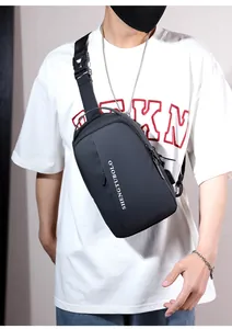 Detail view of black waterproof chest bag with brand logo and adjustable strap