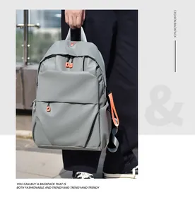 Detail of gray minimalist backpack with orange zipper pulls and waterproof matte fabric