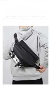 Detail of waterproof black messenger bag showing bottom straps holding a mini tripod