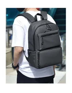Detail view of water-resistant fabric and zippers on black professional laptop backpack