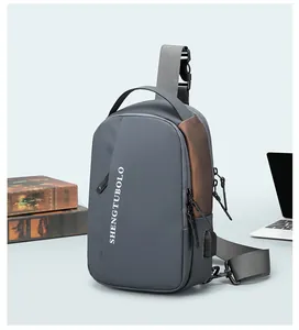 Detail view of a men's gray crossbody bag with a built-in USB port and fabric strap