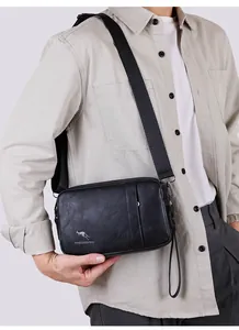 Men's black lychee pattern leather cross-body bag shown worn on model with adjustable strap