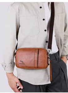 Close-up of brown textured leather shoulder bag with logo detail on male model