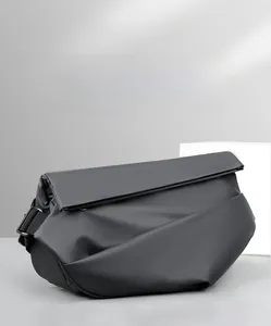 Detail view of the matte black crossbody bag fabric and adjustable strap with premium texture