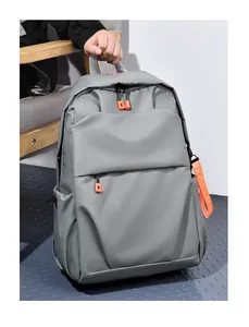 Detail of gray waterproof nylon backpack showing vibrant orange zipper and side strap
