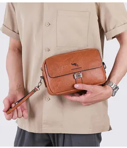 Detailed close-up of brown pebbled leather texture and kangaroo logo on men's hand clutch bag